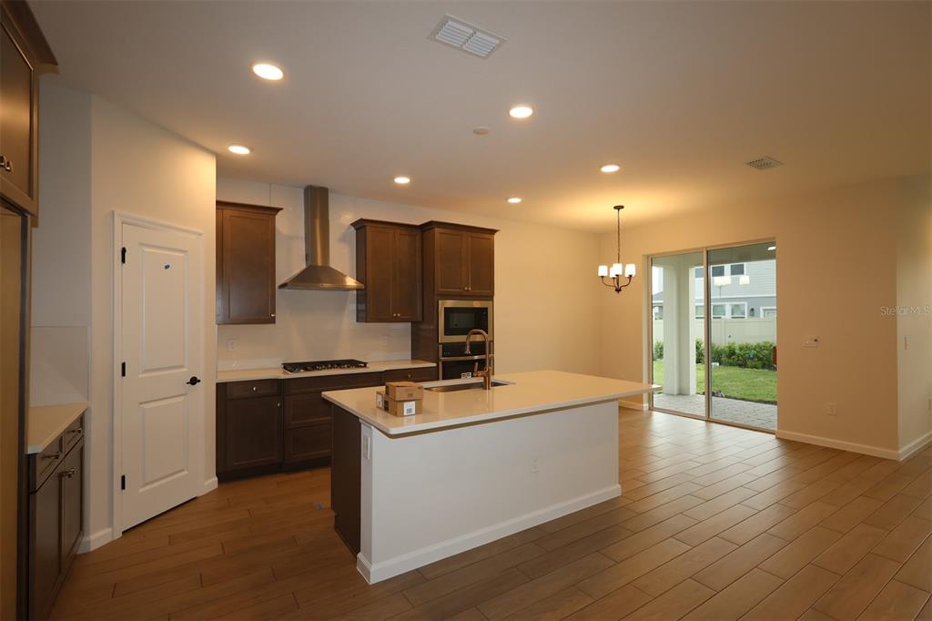5303 High Line Drive St. Cloud, FL 34771 - Photo 3 of 22 a kitchen with stainless steel appliances granite countertop a stove top oven a sink and a refrigerator