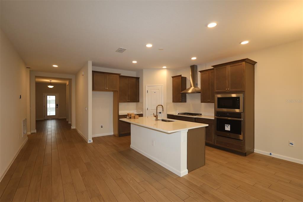 5303 High Line Drive St. Cloud, FL 34771 - Photo 4 of 22 a kitchen with stainless steel appliances granite countertop a stove and a refrigerator