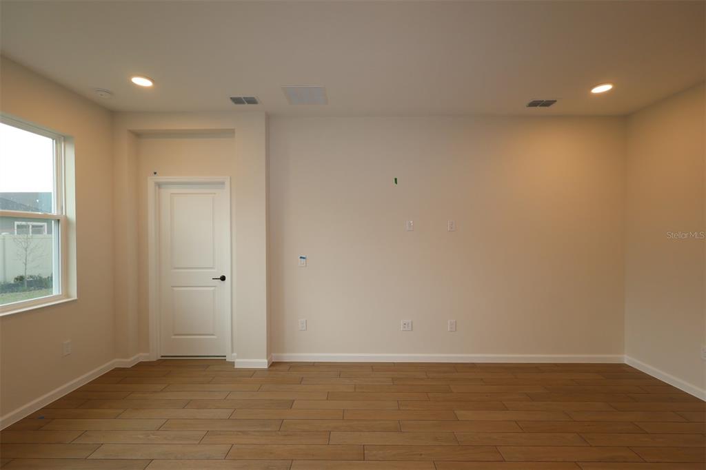 5303 High Line Drive St. Cloud, FL 34771 - Photo 6 of 22 a view of an empty room with wooden floor and a window