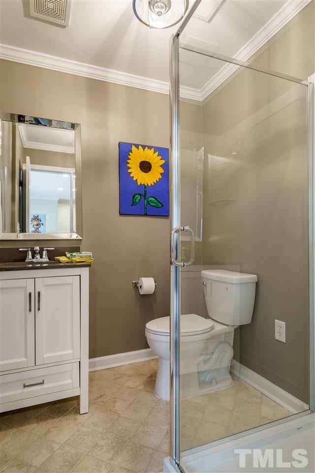 1707 Sutton Drive Raleigh, NC 27605 - Photo 17 of 29 a bathroom with a sink and a mirror