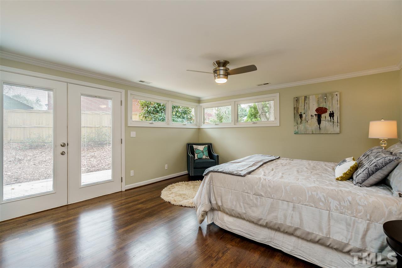 1707 Sutton Drive Raleigh, NC 27605 - Photo 20 of 29 a bedroom with a bed and wooden floor