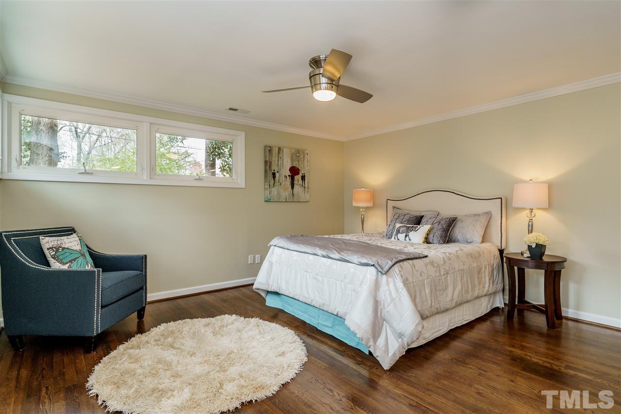 1707 Sutton Drive Raleigh, NC 27605 - Photo 21 of 29 a bedroom with a bed and wooden floor