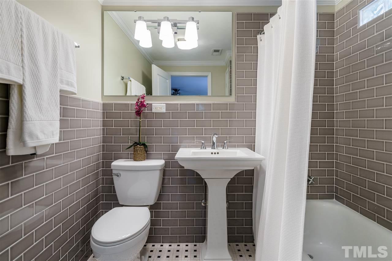 1707 Sutton Drive Raleigh, NC 27605 - Photo 22 of 29 a bathroom with a sink a toilet and mirror