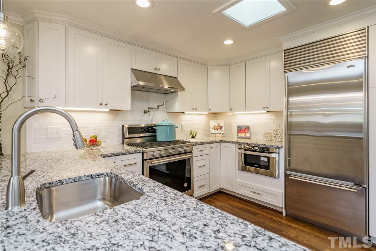 1707 Sutton Drive Raleigh, NC 27605 - Photo 5 of 29 a kitchen with a refrigerator sink and stove