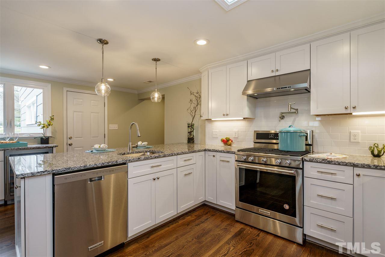 1707 Sutton Drive Raleigh, NC 27605 - Photo 6 of 29 a kitchen with a stove sink and cabinets