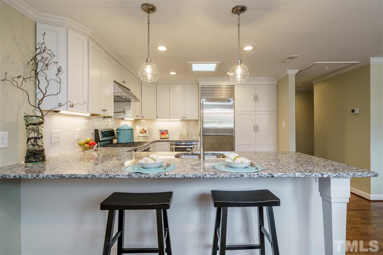 1707 Sutton Drive Raleigh, NC 27605 - Photo 10 of 29 a kitchen with sink and refrigerator
