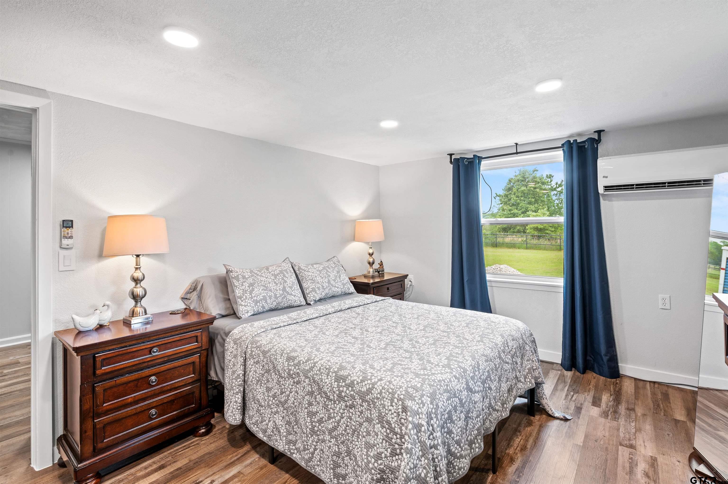 536 County Road 2373 Alba, TX 75410 - Photo 13 of 19 a bedroom with a bed and wooden floor