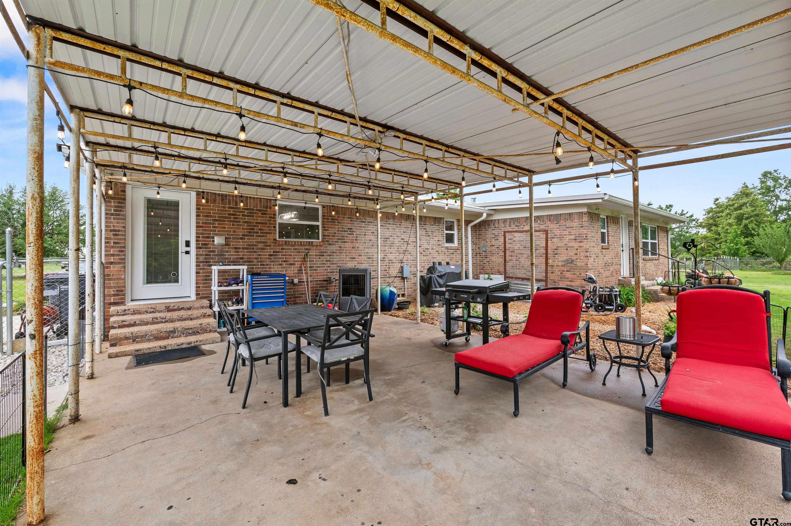 536 County Road 2373 Alba, TX 75410 - Photo 15 of 19 a view of a patio with a table and chairs