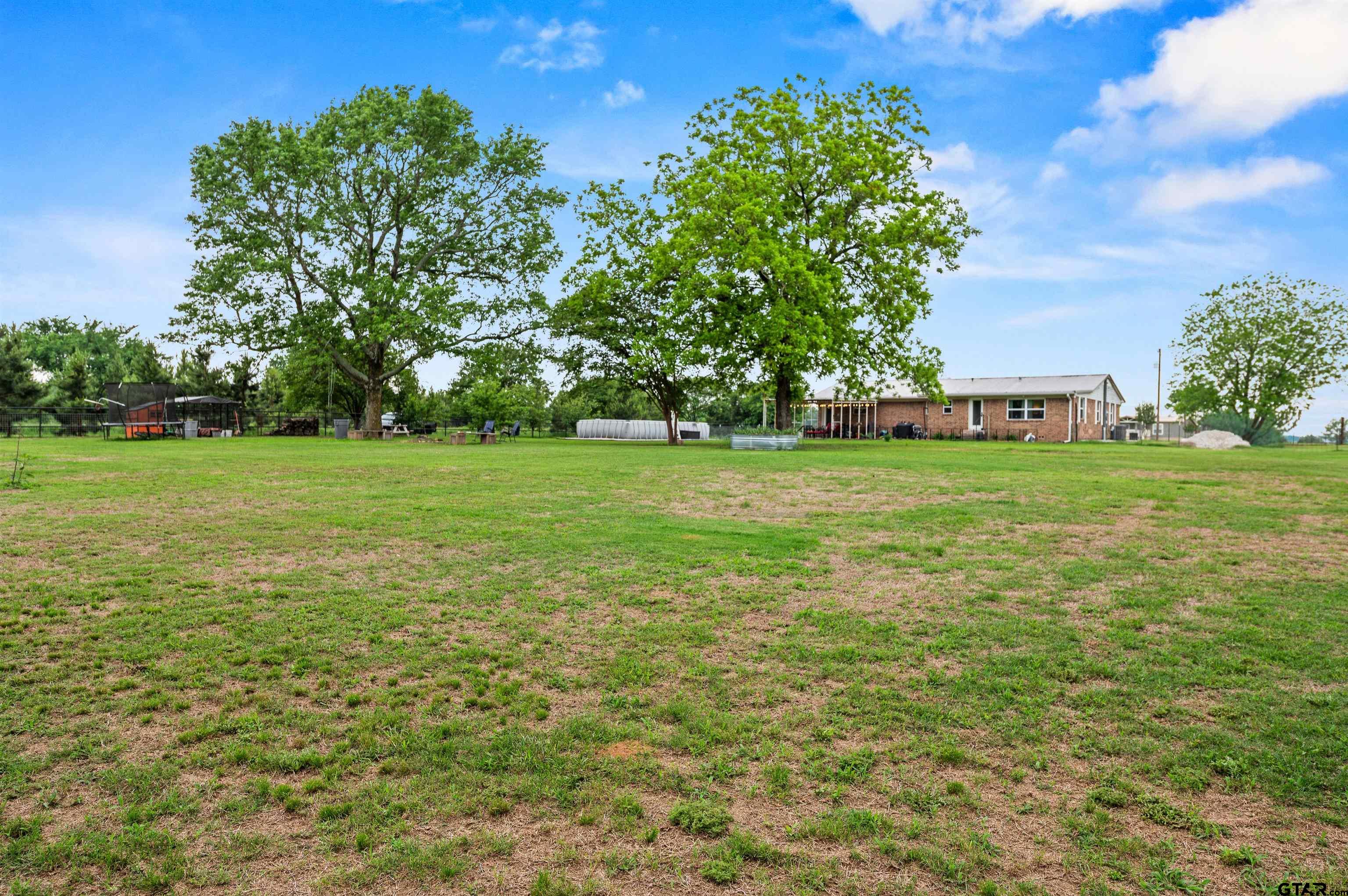 536 County Road 2373 Alba, TX 75410 - Photo 18 of 19 a view of a big yard with a garden