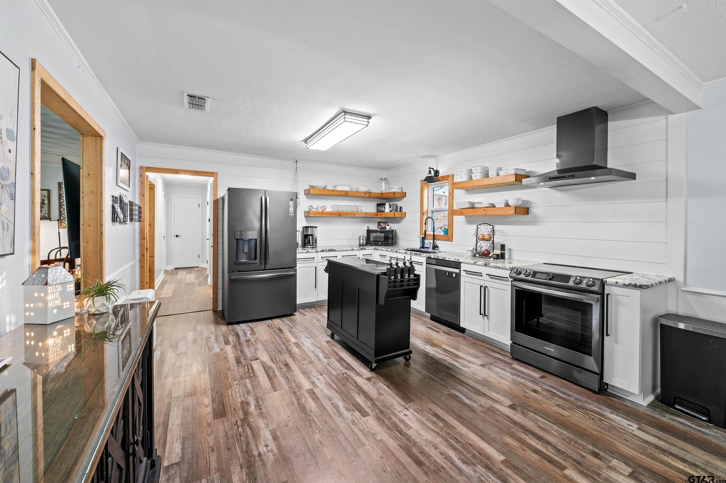 536 County Road 2373 Alba, TX 75410 - Photo 6 of 19 a kitchen with stainless steel appliances a stove a sink dishwasher a refrigerator and a fireplace