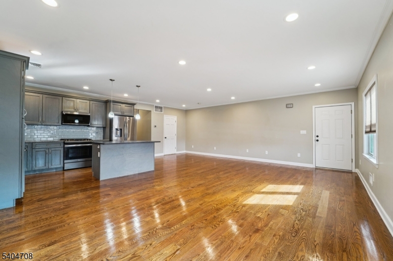 204 Harrison Street Nutley, NJ 07110 - Photo 11 of 23 a view of kitchen with kitchen island granite countertop a stove top oven and a sink with dishwasher