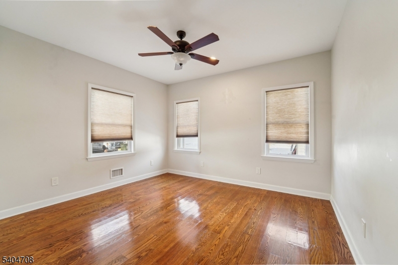 204 Harrison Street Nutley, NJ 07110 - Photo 14 of 23 wooden floor in an empty room with a window