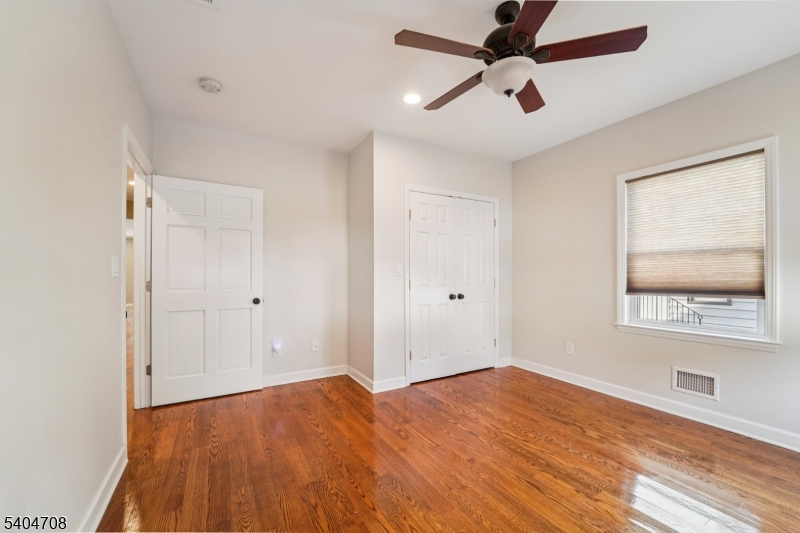 204 Harrison Street Nutley, NJ 07110 - Photo 15 of 23 a view of empty room with wooden floor and fan