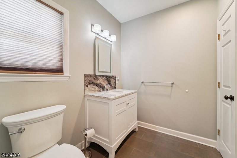 204 Harrison Street Nutley, NJ 07110 - Photo 16 of 23 a bathroom with a toilet sink and mirror