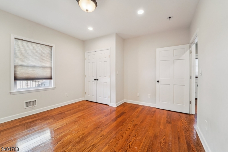 204 Harrison Street Nutley, NJ 07110 - Photo 19 of 23 a view of empty room with wooden floor and window