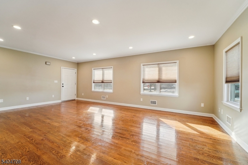 204 Harrison Street Nutley, NJ 07110 - Photo 2 of 23 a view of an empty room with wooden floor and a window