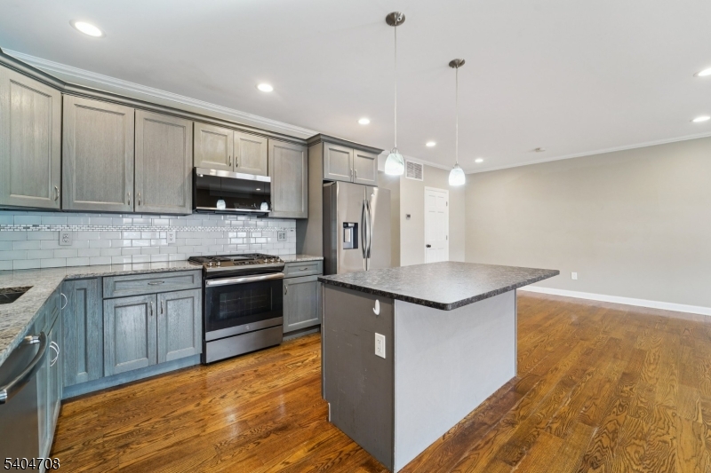 204 Harrison Street Nutley, NJ 07110 - Photo 3 of 23 a kitchen with stainless steel appliances granite countertop a stove a sink and a refrigerator