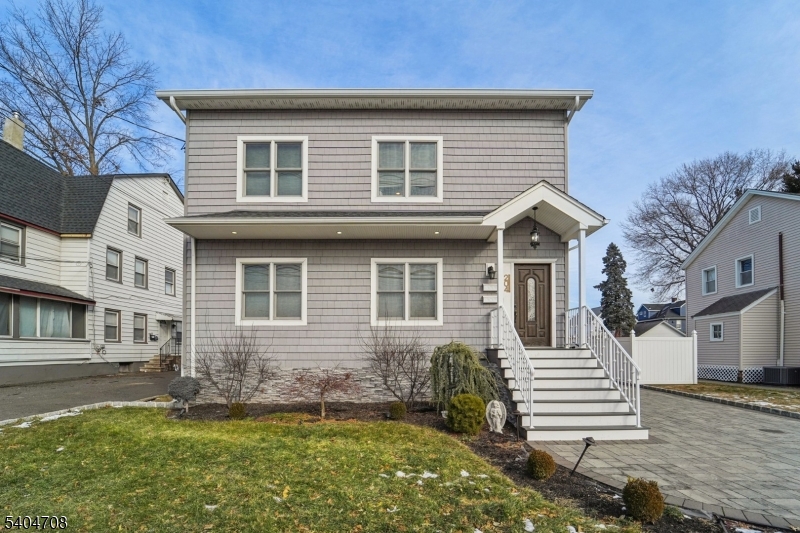 204 Harrison Street Nutley, NJ 07110 - Photo 6 of 23 a front view of a house with a yard