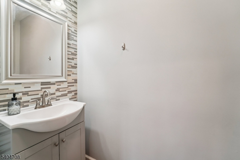 204 Harrison Street Nutley, NJ 07110 - Photo 7 of 23 a bathroom with a sink and a mirror