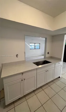 a kitchen with white cabinets