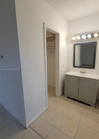 a bathroom with a sink a mirror and a bathtub
