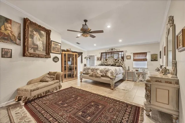 a bedroom with a large bed and a chandelier