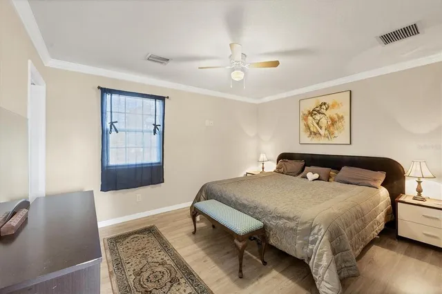 a bed sitting in a bedroom and view of living room