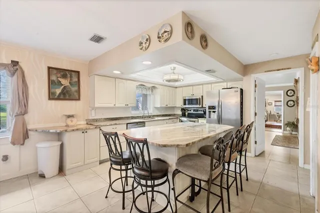 a large kitchen with a table and chairs