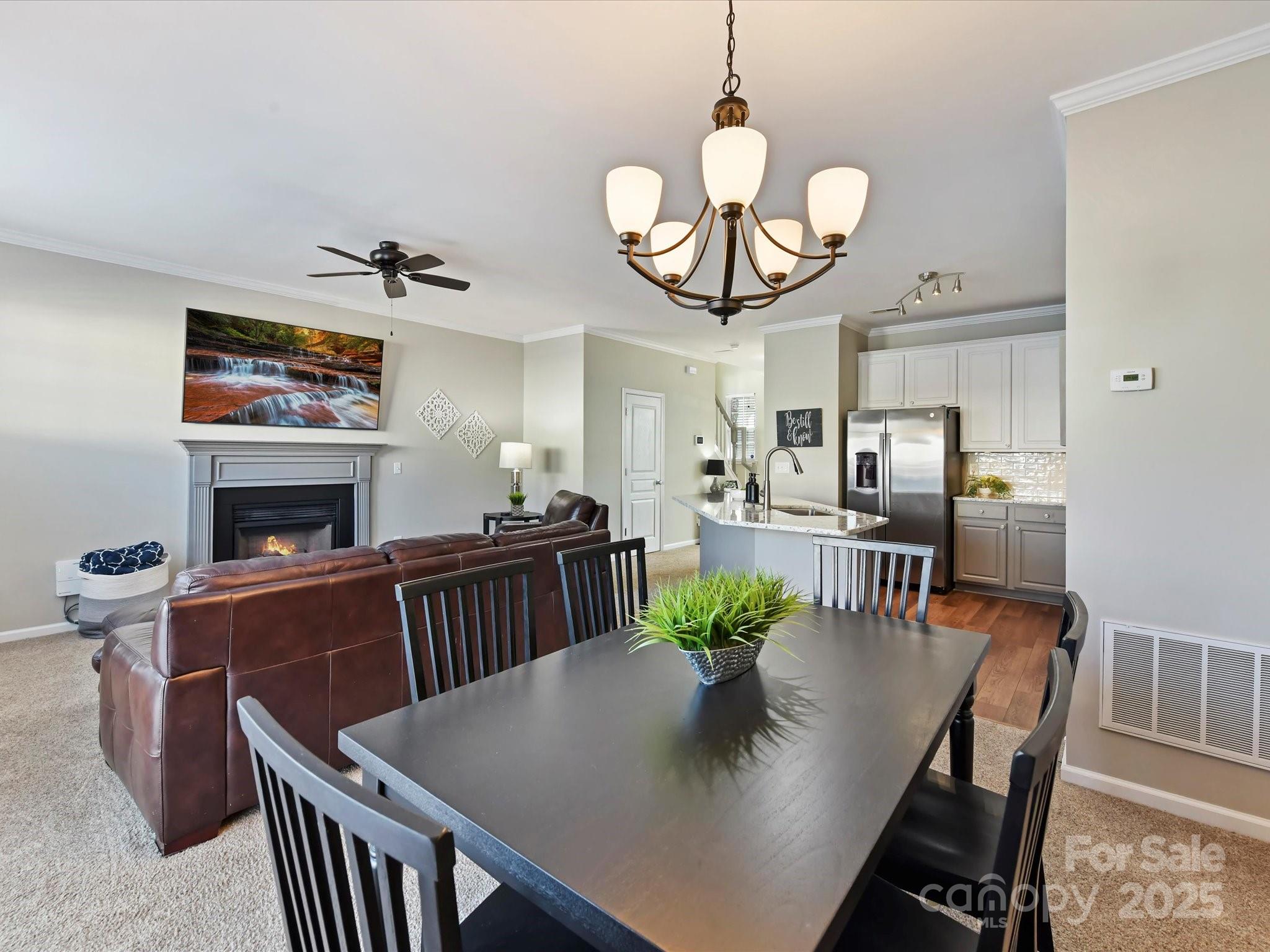836 Gentlewinds Court Fort Mill, SC 29708 - Photo 11 of 29 a view of a dining room with furniture a chandelier and wooden floor
