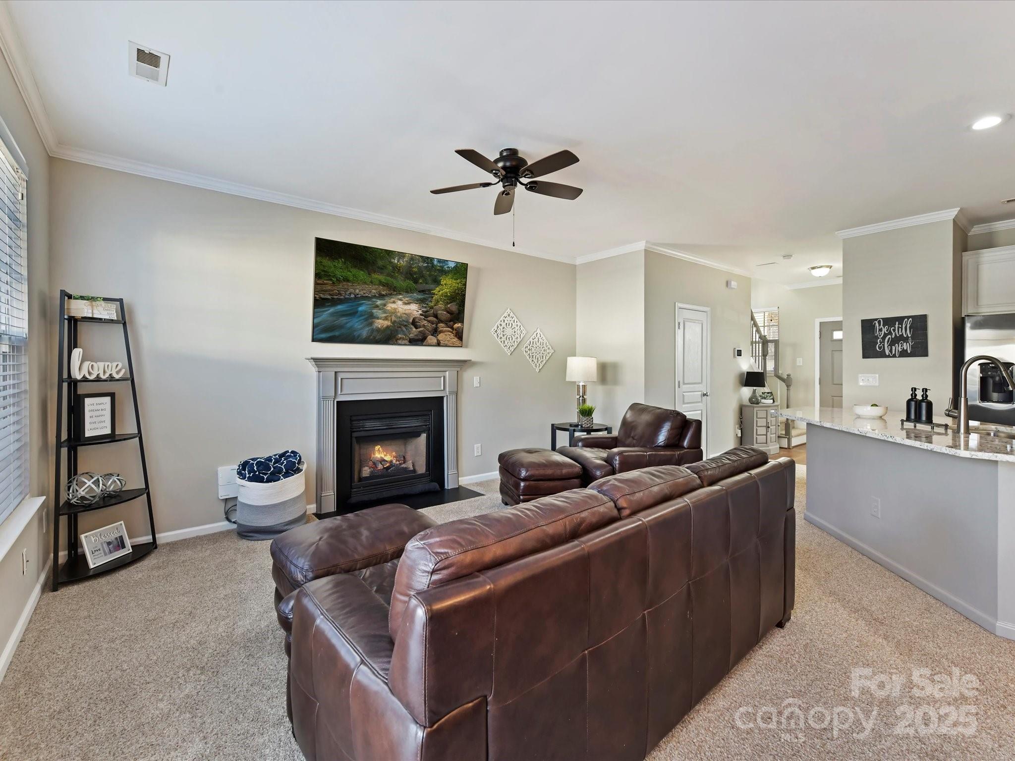 836 Gentlewinds Court Fort Mill, SC 29708 - Photo 13 of 29 a living room with furniture a flat screen tv and a fireplace