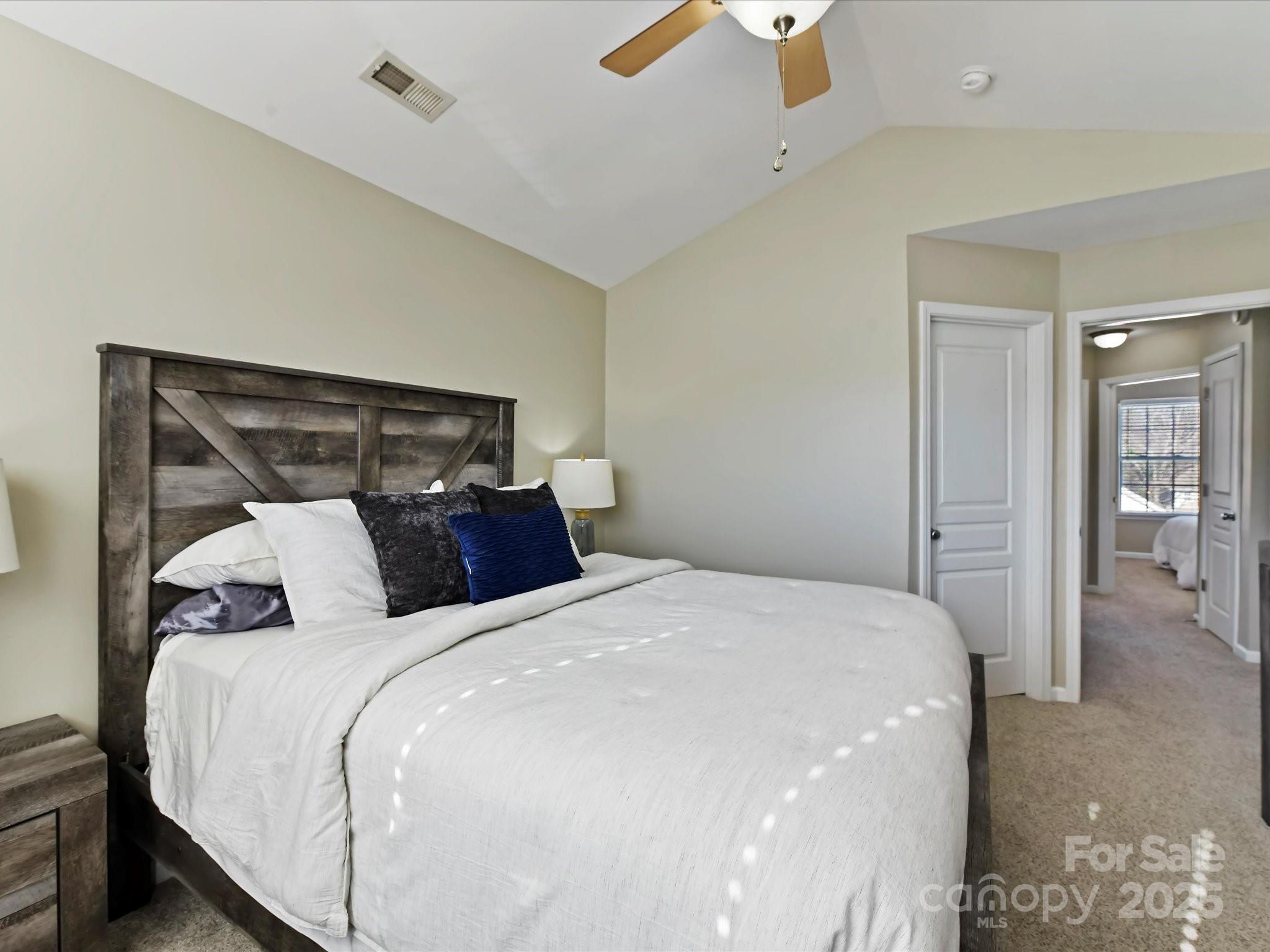 836 Gentlewinds Court Fort Mill, SC 29708 - Photo 18 of 29 a bedroom with a large bed and a chandelier