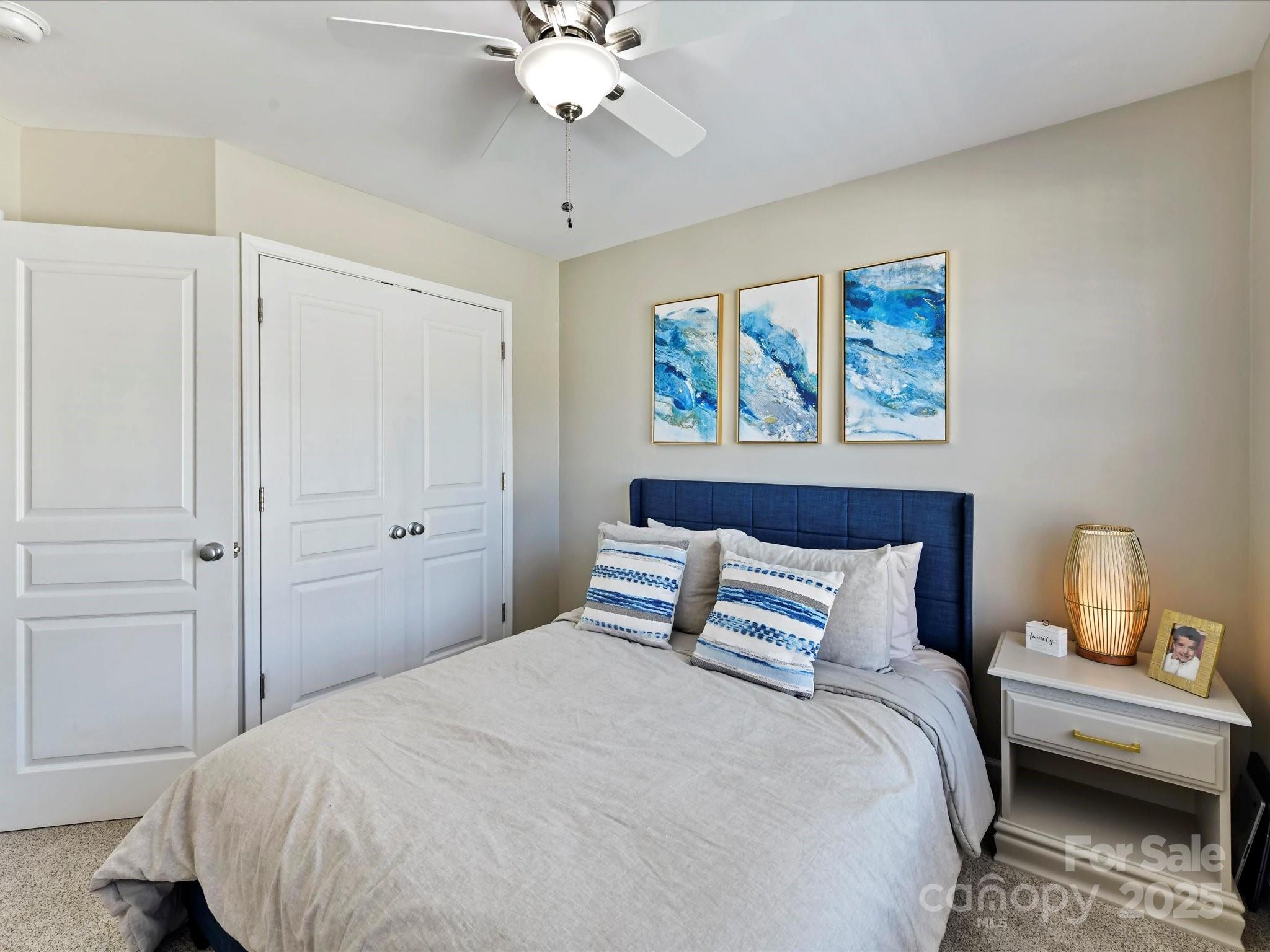 836 Gentlewinds Court Fort Mill, SC 29708 - Photo 22 of 29 a bedroom with a bed and a painting on the wall