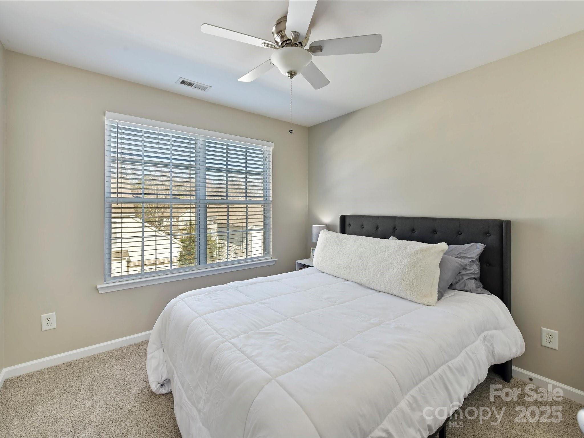 836 Gentlewinds Court Fort Mill, SC 29708 - Photo 24 of 29 a bedroom with a bed and window