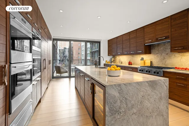 a kitchen with stainless steel appliances granite countertop a sink a stove and a refrigerator