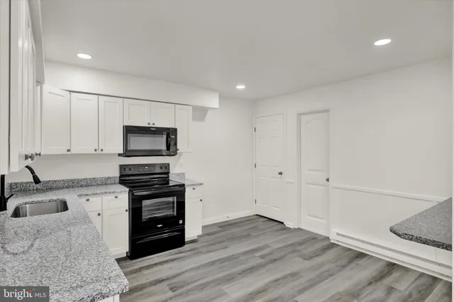 a kitchen with wooden cabinets and white appliances