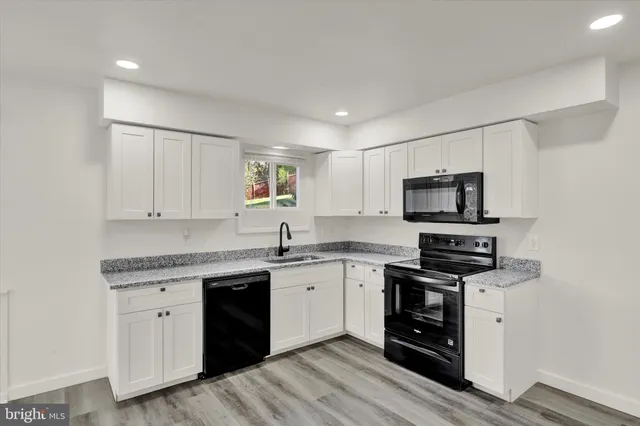 a kitchen with appliances cabinets and a sink