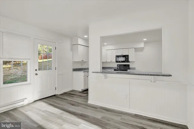 a view of a kitchen with a sink a refrigerator and window