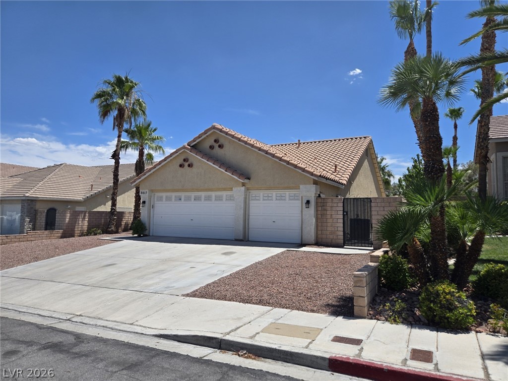 8417 San Ramon Drive Las Vegas, NV 89147 - Photo 1 of 33 A traditional tile roof home with an inviting driveway and mature palm trees.