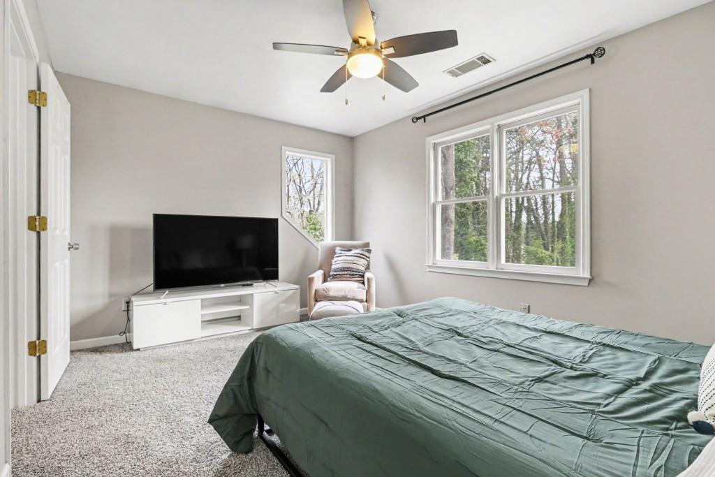 3793 Market Crescent Clarkston, GA 30021 - Photo 27 of 35 a bedroom with a bed and a flat screen tv