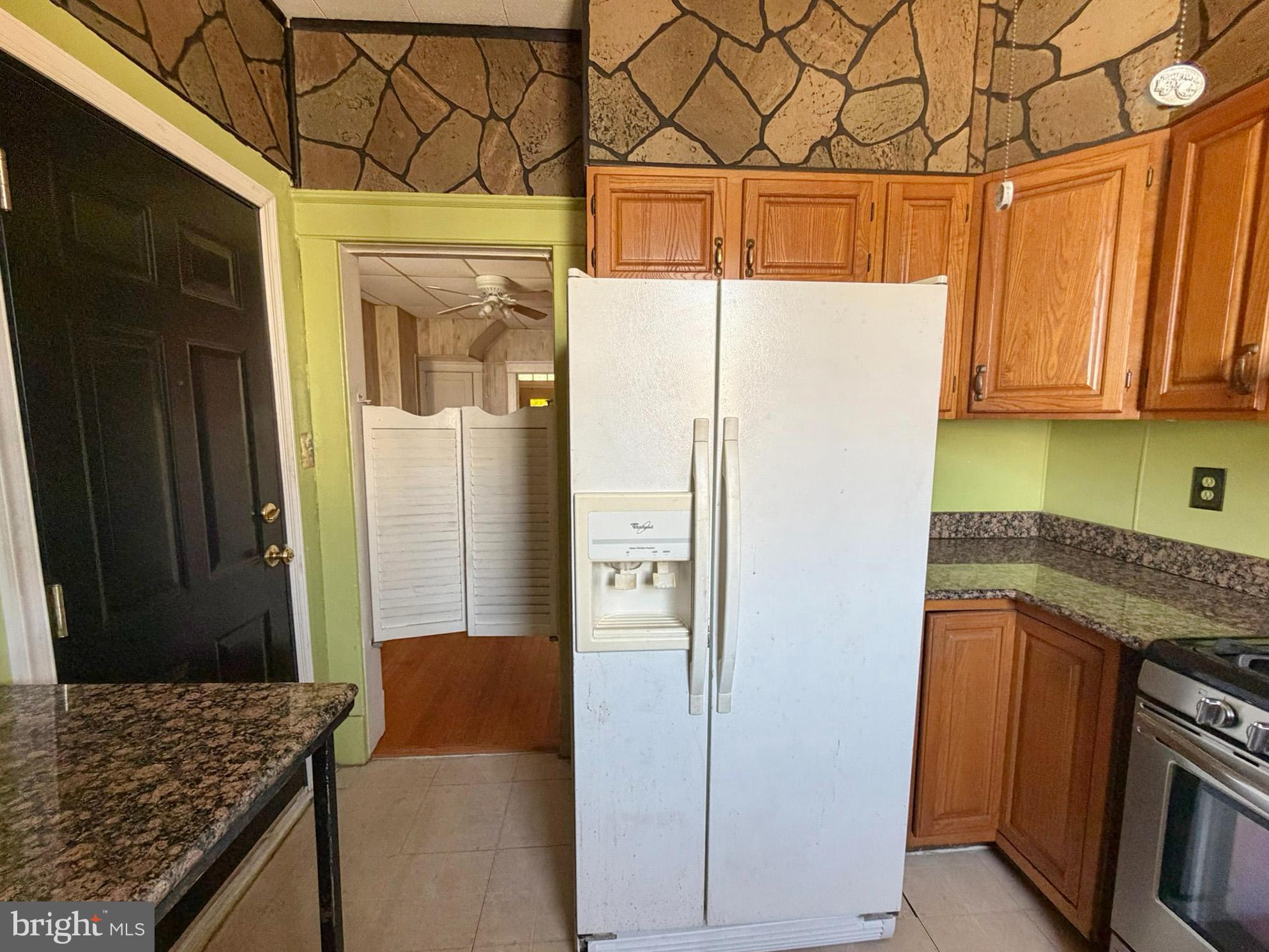 2802 Brighton Street Baltimore, MD 21216 - Photo 12 of 38 a kitchen with a refrigerator and a stove
