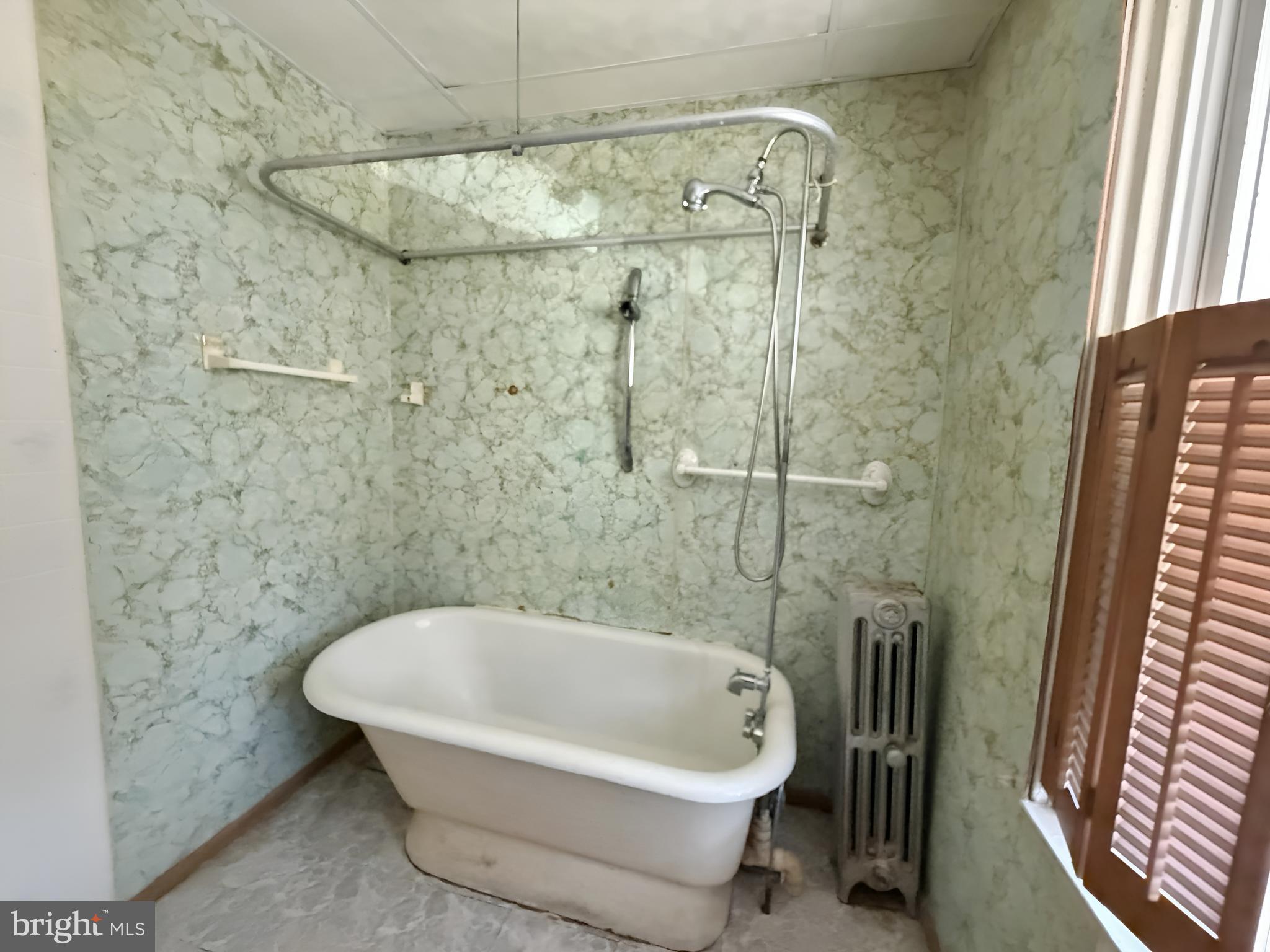 2802 Brighton Street Baltimore, MD 21216 - Photo 14 of 38 a bathroom with a bathtub and shower
