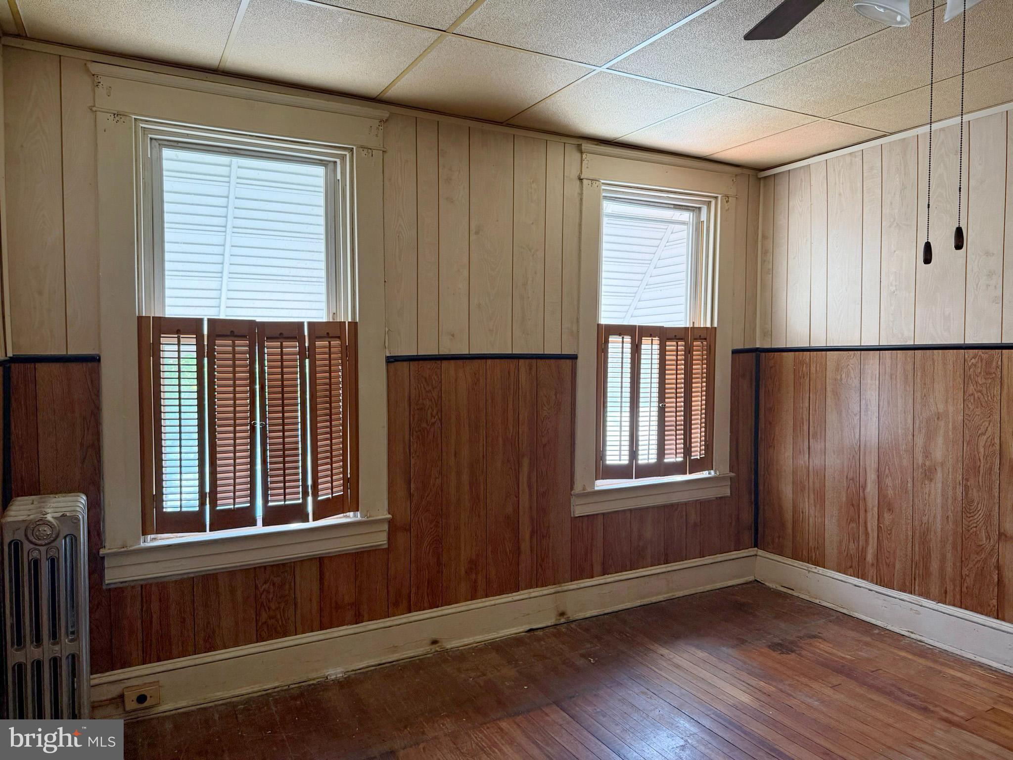 2802 Brighton Street Baltimore, MD 21216 - Photo 16 of 38 an empty room with wooden floor and windows