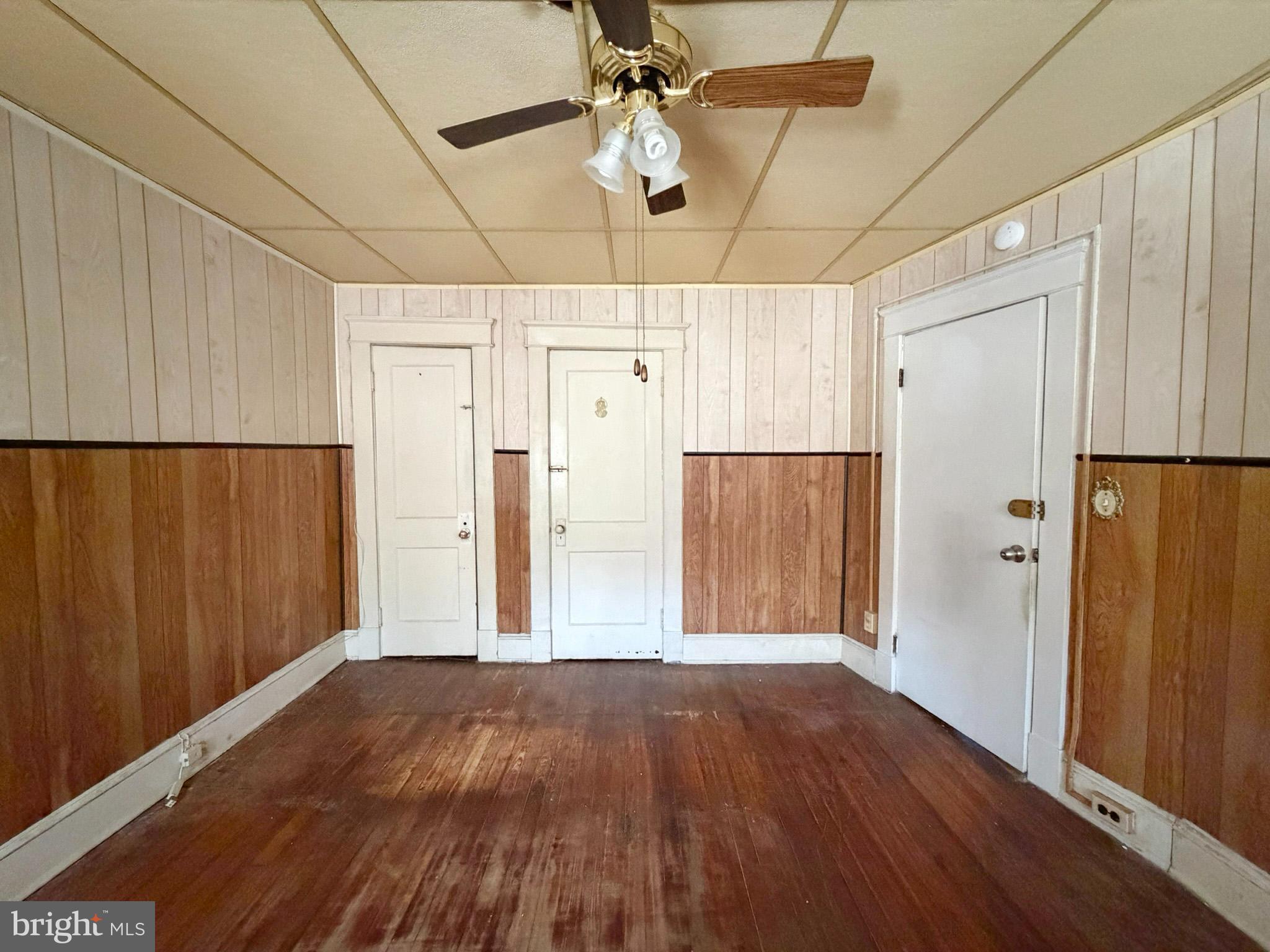 2802 Brighton Street Baltimore, MD 21216 - Photo 17 of 38 a view of a livingroom with wooden floor ceiling fan
