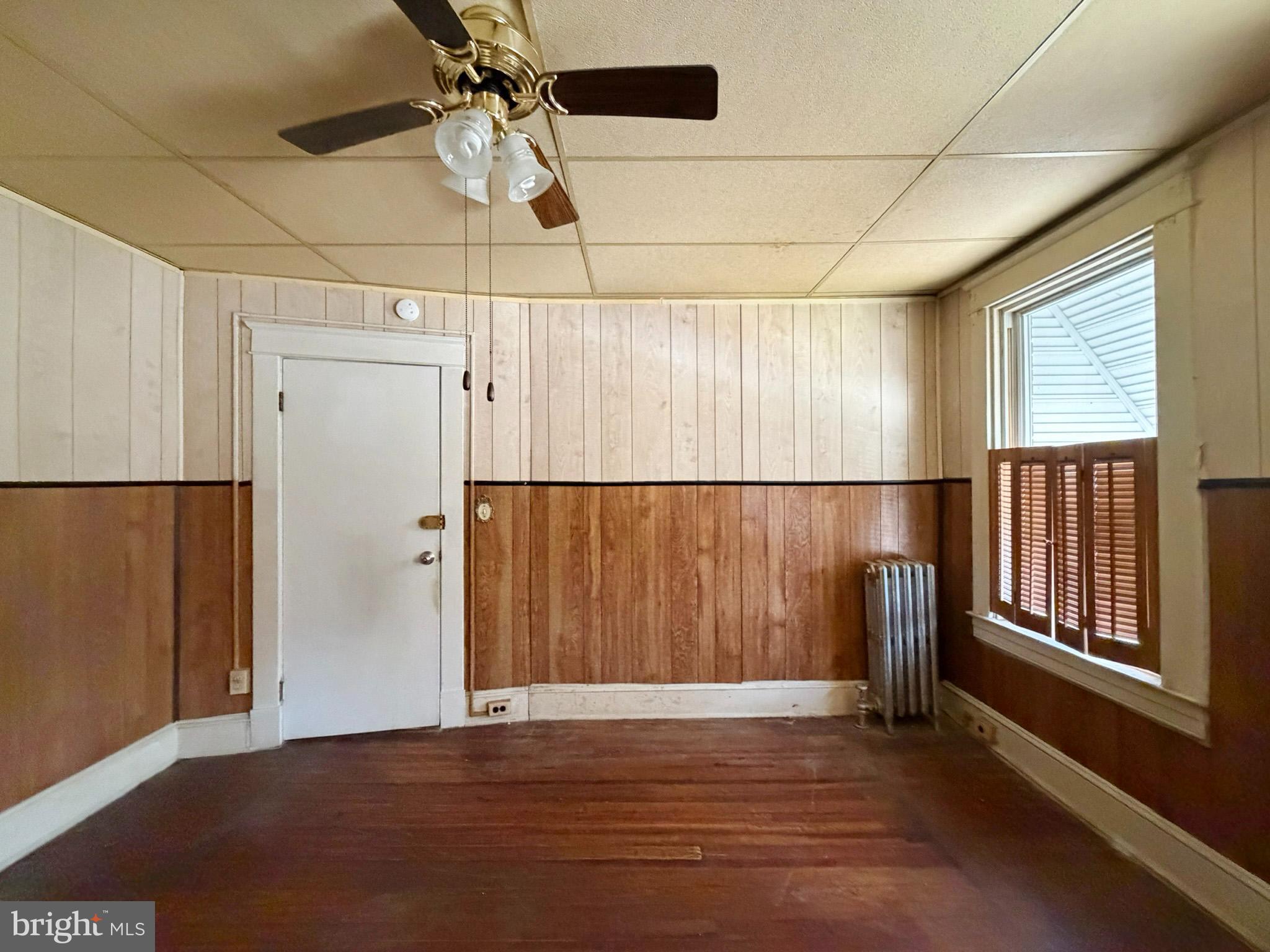 2802 Brighton Street Baltimore, MD 21216 - Photo 18 of 38 an empty room with wooden floor and windows