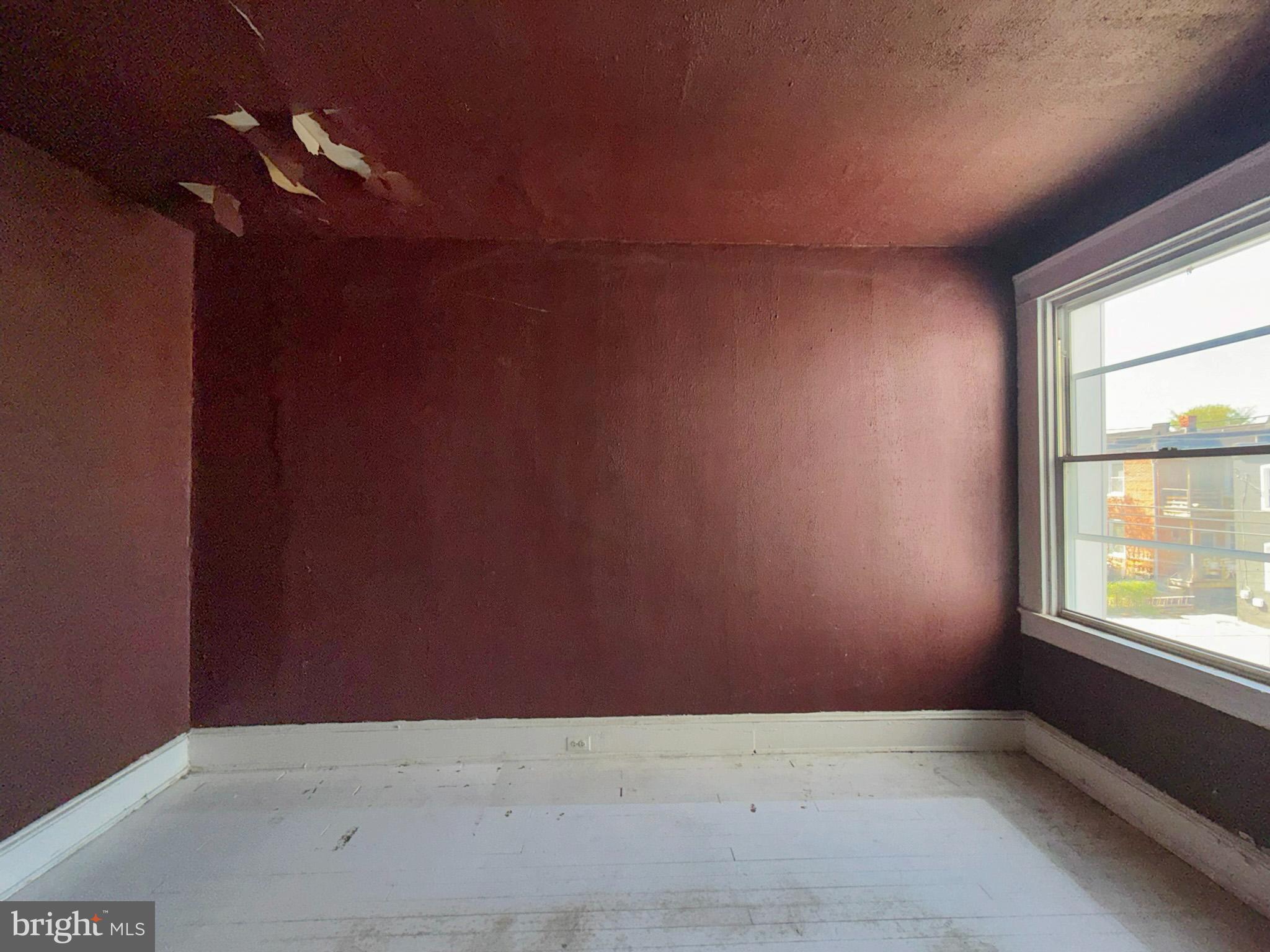 2802 Brighton Street Baltimore, MD 21216 - Photo 19 of 38 an empty room with windows and fan