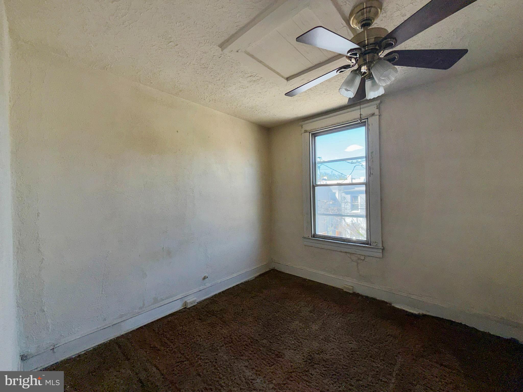 2802 Brighton Street Baltimore, MD 21216 - Photo 25 of 38 an empty room with a window and a fan