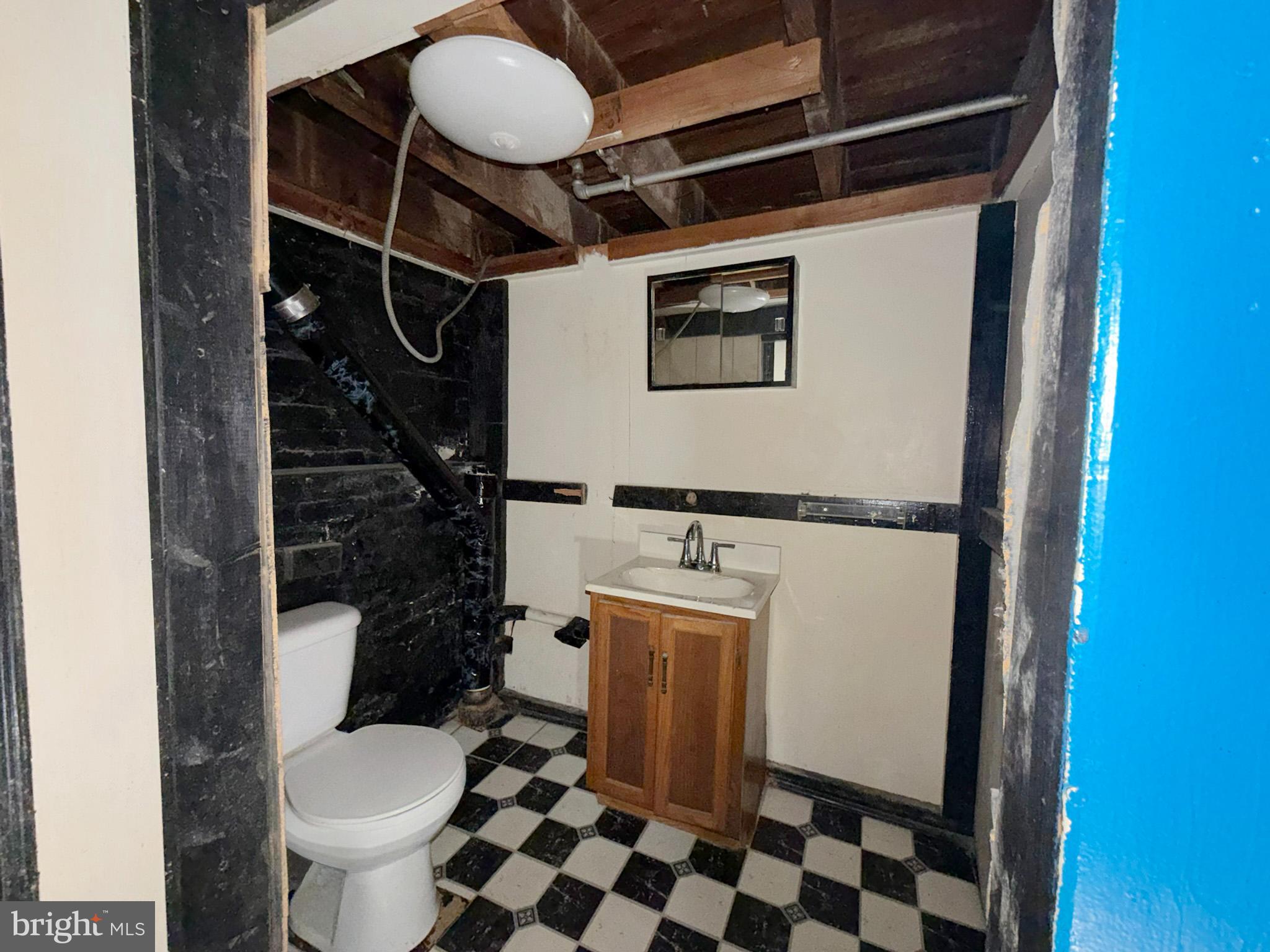 2802 Brighton Street Baltimore, MD 21216 - Photo 28 of 38 a bathroom with a sink toilet and shower