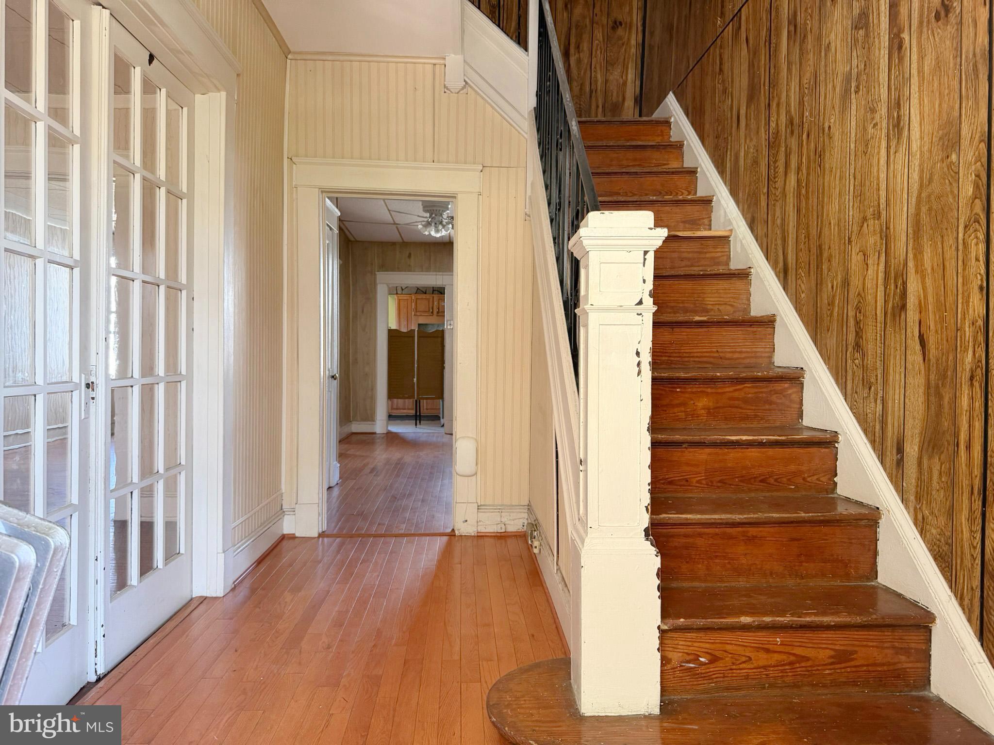 2802 Brighton Street Baltimore, MD 21216 - Photo 3 of 38 a view of staircase with wooden floor and white walls