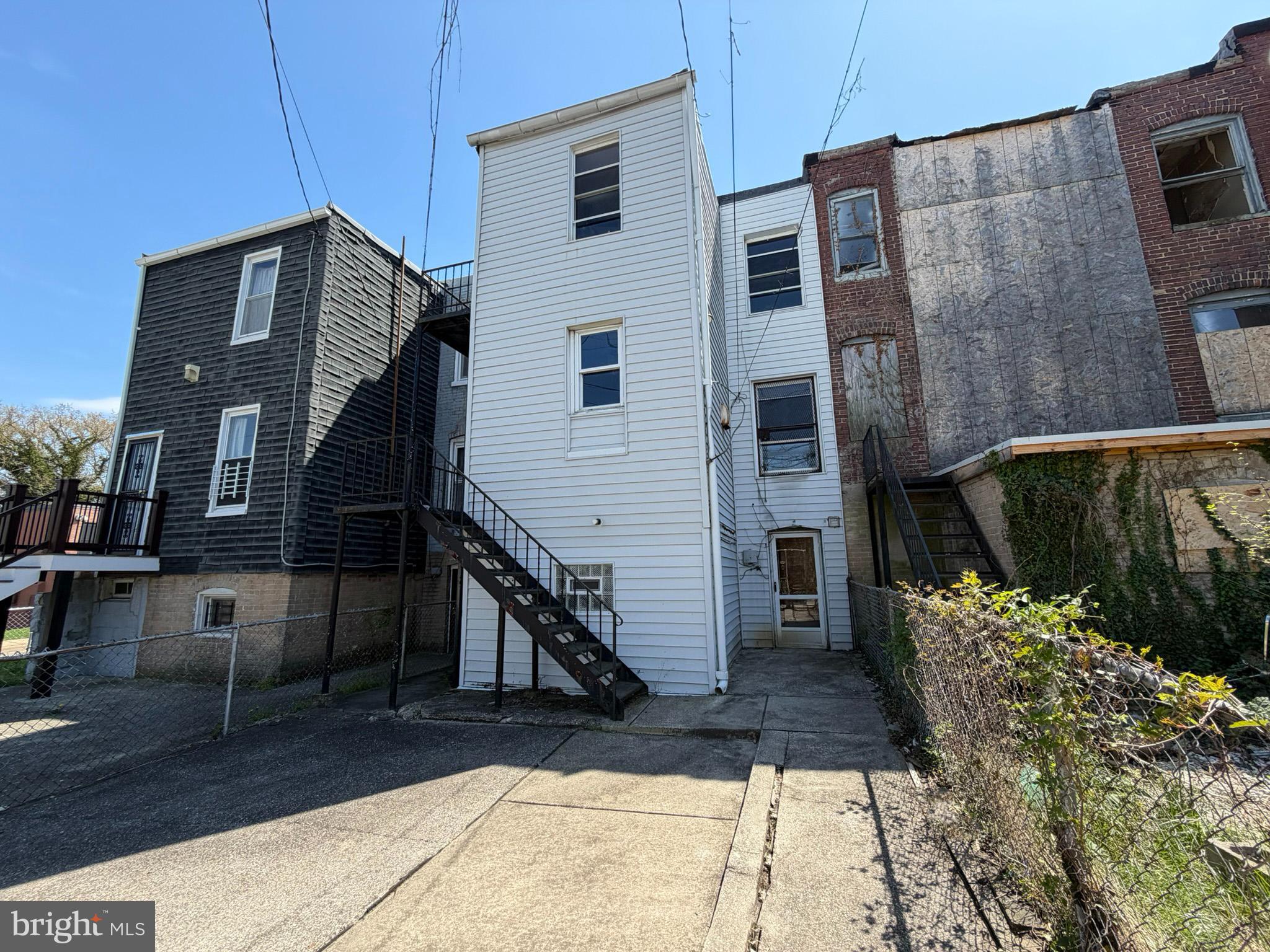 2802 Brighton Street Baltimore, MD 21216 - Photo 36 of 38 a view of a house with a door and wooden walls