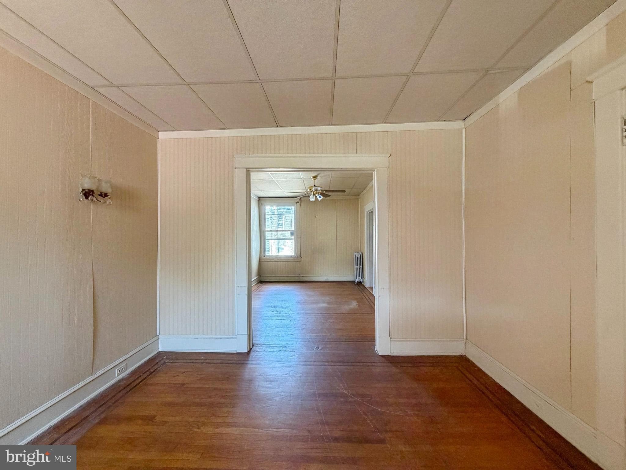 2802 Brighton Street Baltimore, MD 21216 - Photo 5 of 38 a view of a hallway with wooden floor